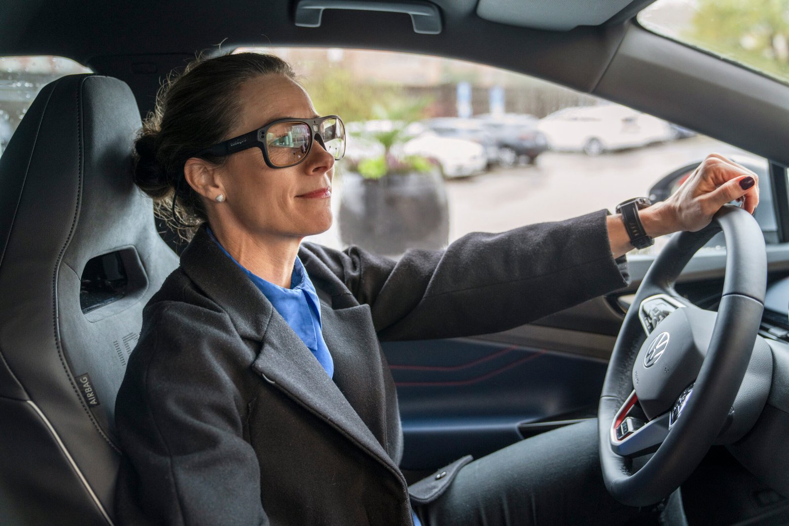 Driver wearing Tobii Pro Glasses 3 at the wheel of a car