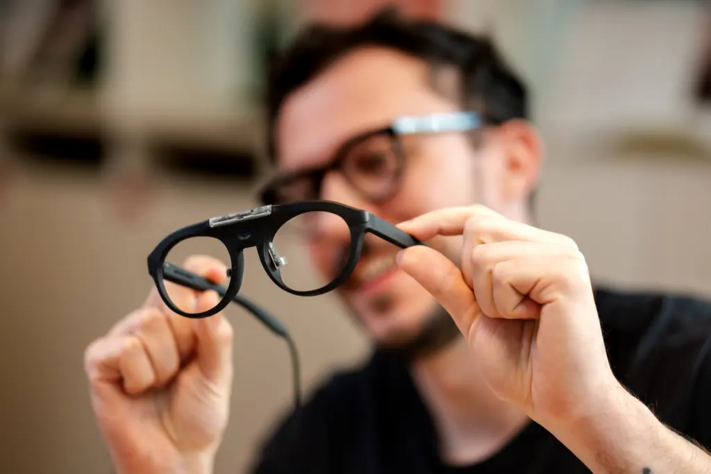 Researcher holding a pair of eye-tracking glasses