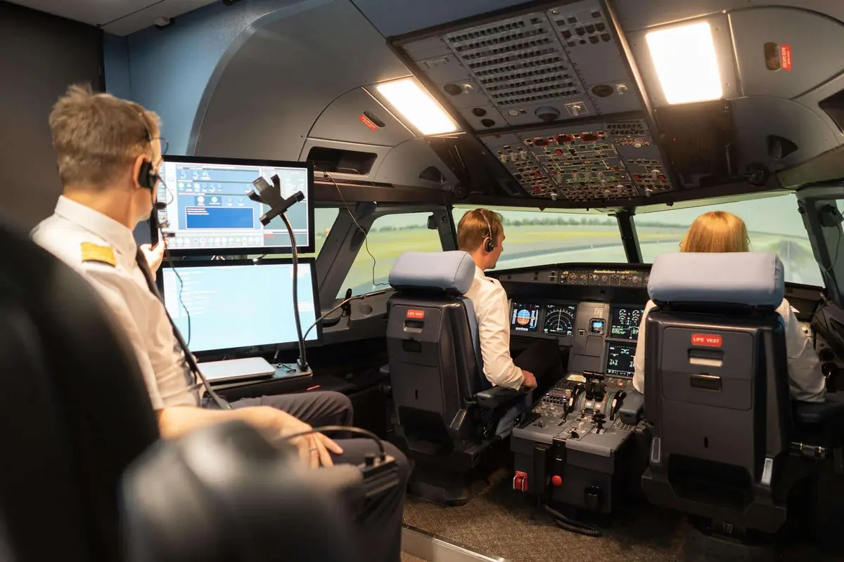 Pilots in a flight simulator cockpit