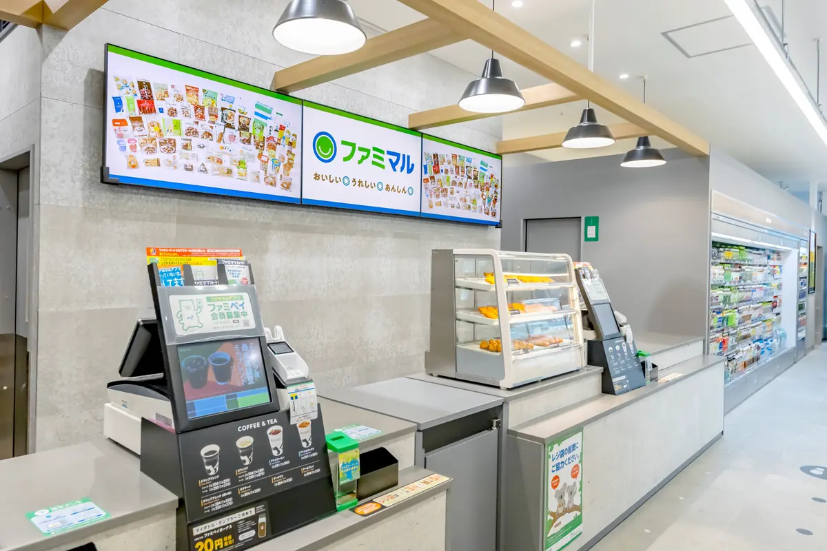 Family Mart Vision digital screens above a checkout counter