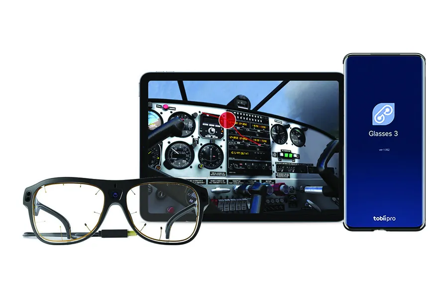 Tobii Pro Glasses 3 Controller on a tablet and phone beside the glasses